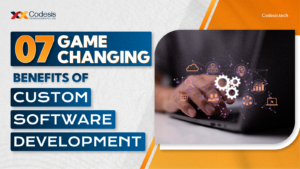 the image with the text as 7 game changing benefits of custom software development with the image of a person using a laptop with a tech background